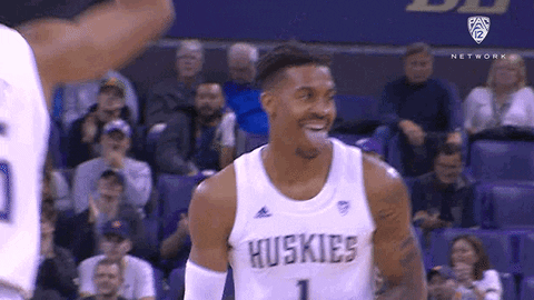 Basketball Player in Huskies Jersey Laughing During Game