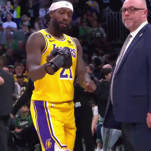Basketball Player In Lakers Jersey Holding Camera GIF