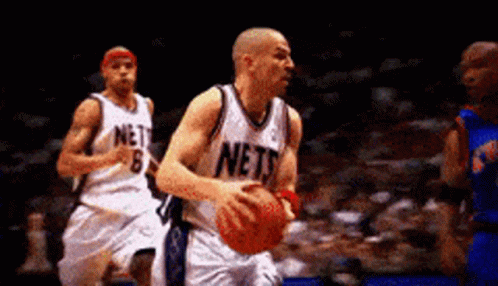 Basketball Player in Nets Jersey Dribbling