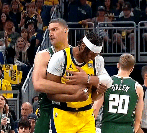 Basketball Player in Number 20 Jersey Hugging Another Player