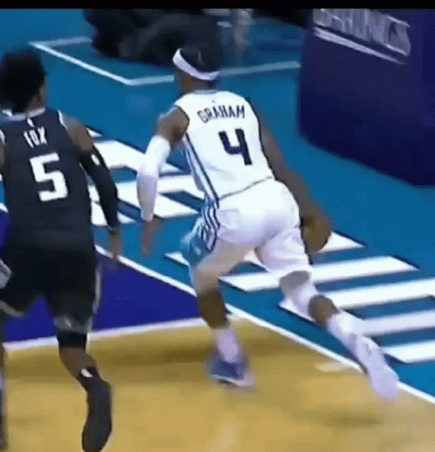 Basketball Player in Number 4 Jersey Dribbling