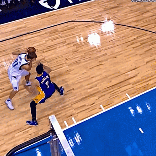 Basketball Player in Number 7 Jersey Blocking Player