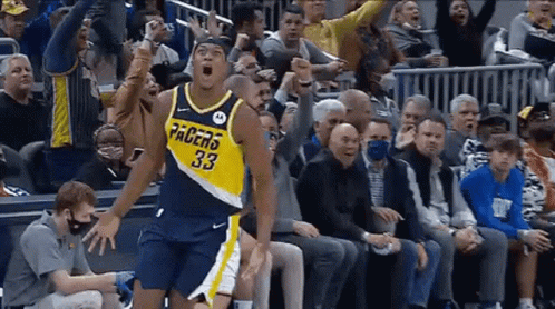 Basketball Player in Pacers Jersey Jumping in Front of Crowd