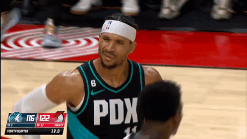 Basketball Player in PDX Jersey Talking to Another