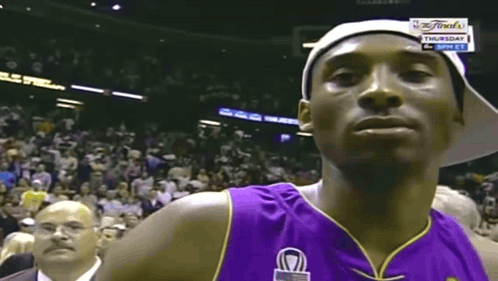 Basketball Player in Purple Jersey and White Hat