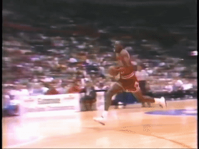 Basketball Player in Red and White Uniform Dribbling