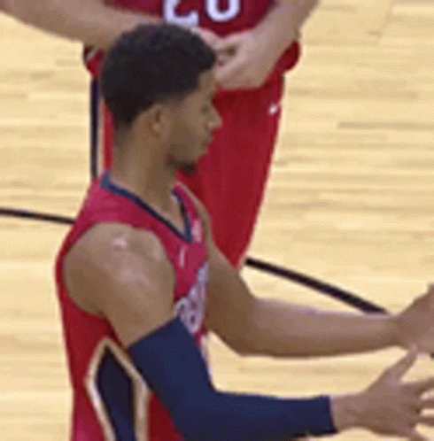 Basketball Player in Red Jersey on Court