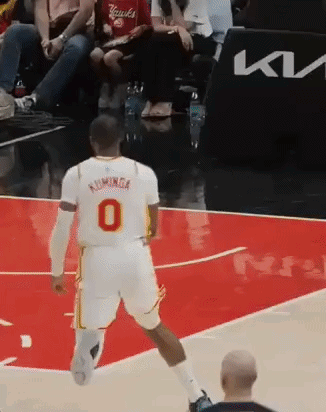 Basketball Player in White Jersey Number 0 Running