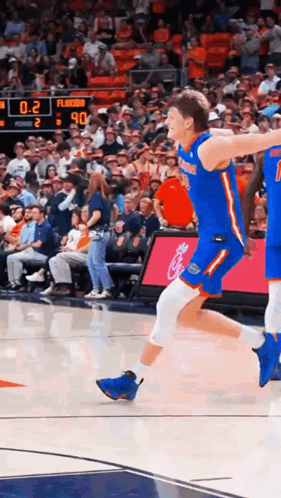 Basketball Player Jumping During Game With Watcher