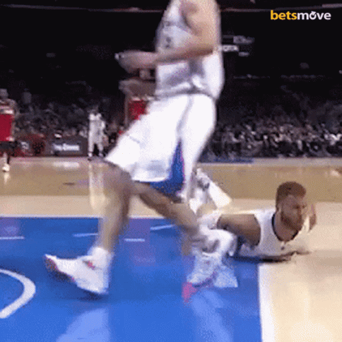 Basketball Player Jumps Over Downed Player