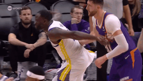 Basketball Player Kicking Another