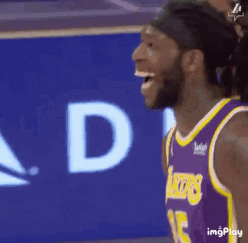 Basketball Player Laughing in Purple and Yellow Jersey