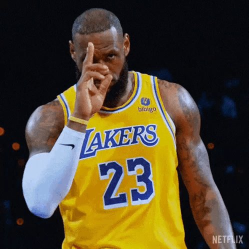 Basketball Player Lebron James Is Wearing A Yellow Lakers Jersey And Pointing At The Camera . GIF