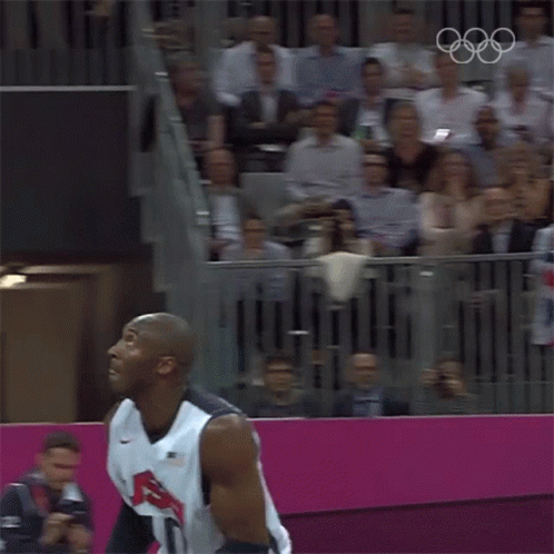Basketball Player Number 10 Jumping to Catch Ball