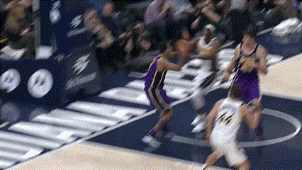 Basketball Player Number 14 Driving Past Defender