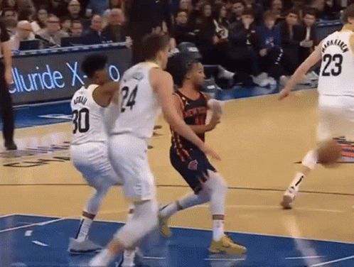 Basketball Player Number 24 Surrounded by Players