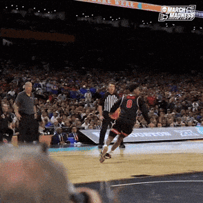 Basketball Player Number 8 Fouled by Referee