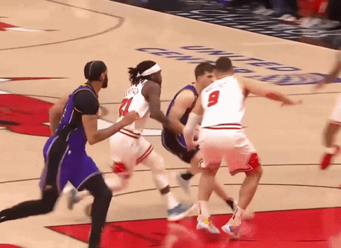 Basketball Player Number 9 Blocking Player Number 21 GIF