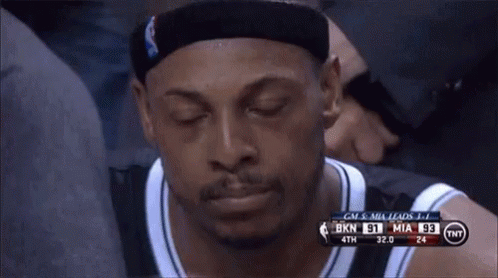 Basketball Player Sitting in Stands Eyes Closed