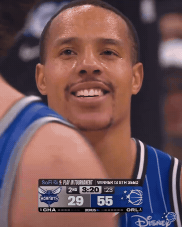 Basketball Player Smiling At Scoreboard GIF