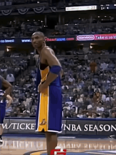Basketball Player Standing in Front of NBA Season Sign