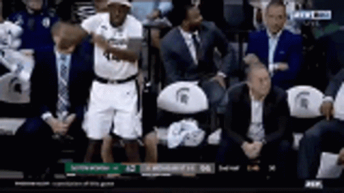 Basketball Player Standing in Stands During Game
