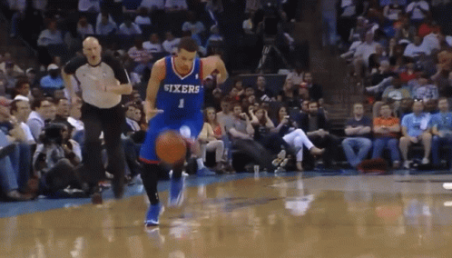Basketball Player Wearing A Sixers Jersey Dribbles The Ball GIF
