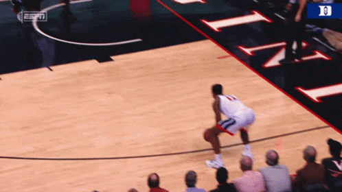 Basketball Player Wearing Number 13 Dribbling