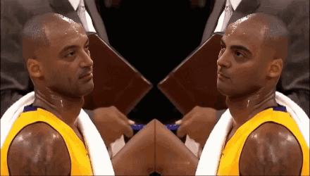 Basketball Player With Towel Around Neck Looking at Camera