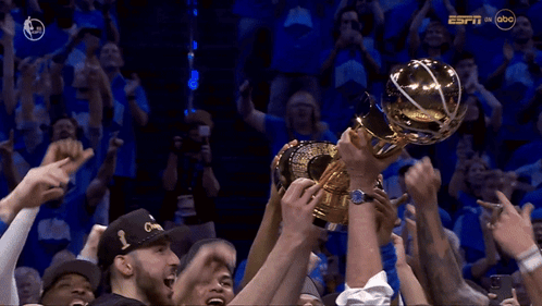 Basketball Players Holding Trophy