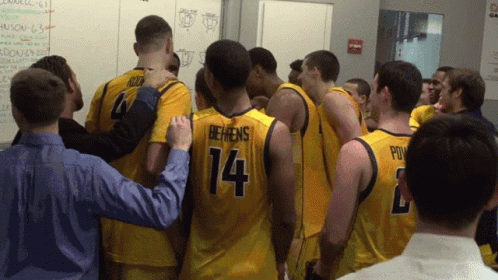 Basketball Players Huddled Including Number 14