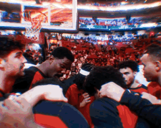 Basketball Players Hugging in Stadium