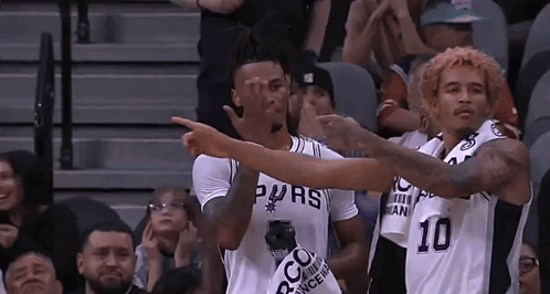 Basketball Players in Spurs Jerseys Pointing