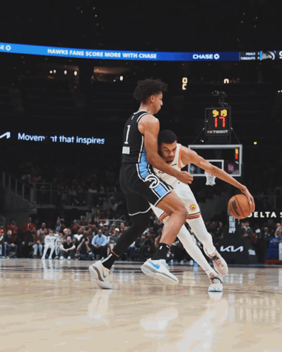 Basketball Players Near Sign Offering $20 Off Merch GIF