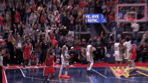 Basketball Players On A Court With A Sign That Says Bye Plastic In The Background GIF