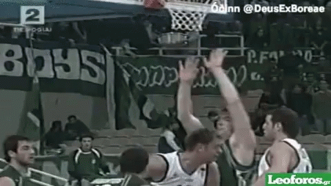 Basketball Players Playing in Front of Boys Banner