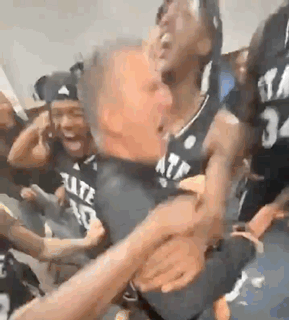 Basketball Players Sitting in Locker Room