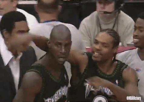 Basketball Players Sitting In Stadium With Timberwolves Jersey GIF