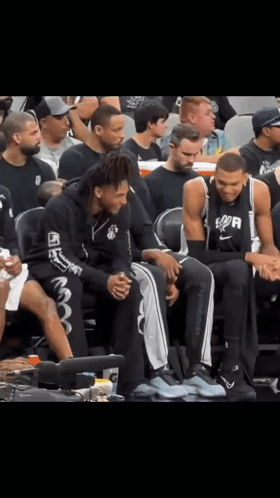 Basketball Players Sitting On Bench Spurs Shirt GIF