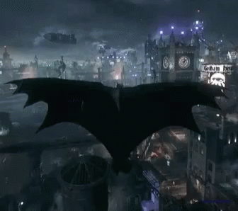 Bat Flying Over City Night Getham Hotel Sign GIF