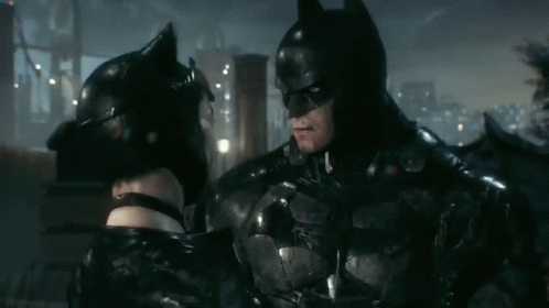 Batman And Catwoman Are Standing Next To Each Other And Looking At Each Other GIF
