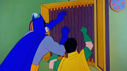 Batman And Robin Are Standing Next To Each Other In Front Of A Cabinet . GIF