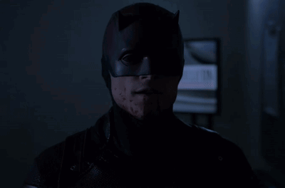 Batman Mask Man Stares at Camera in Dark