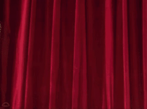 Beaker From The Muppet Show Is Holding A Chainsaw In Front Of A Red Curtain GIF