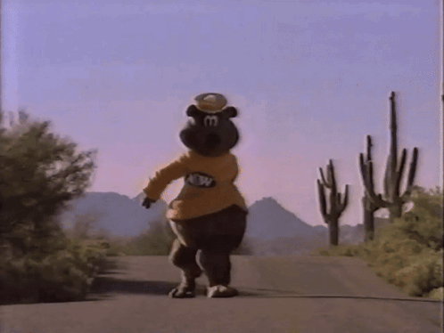 Bear Mascot Walking Past Cactus