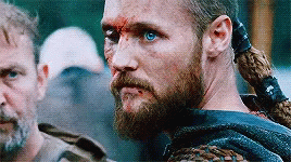 Bearded Blue-Eyed Man Next To Ponytailed Man GIF