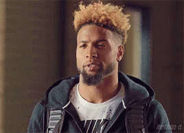 Bearded Curly Haired Man in Hoodie and White Shirt