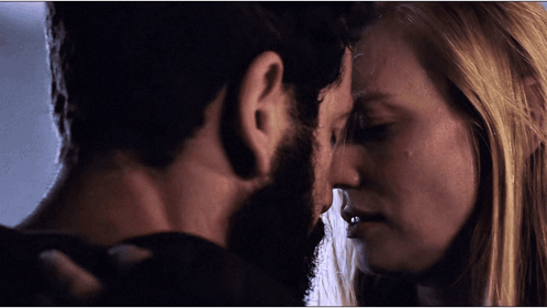 Bearded Man and Blonde Woman Locking Eyes