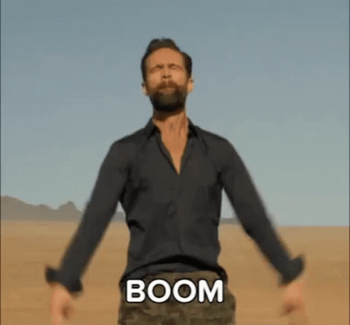 Bearded Man Arms Outstretched Desert With Boom On Chest GIF