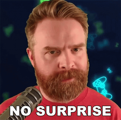 Bearded Man at Microphone Saying No Surprise